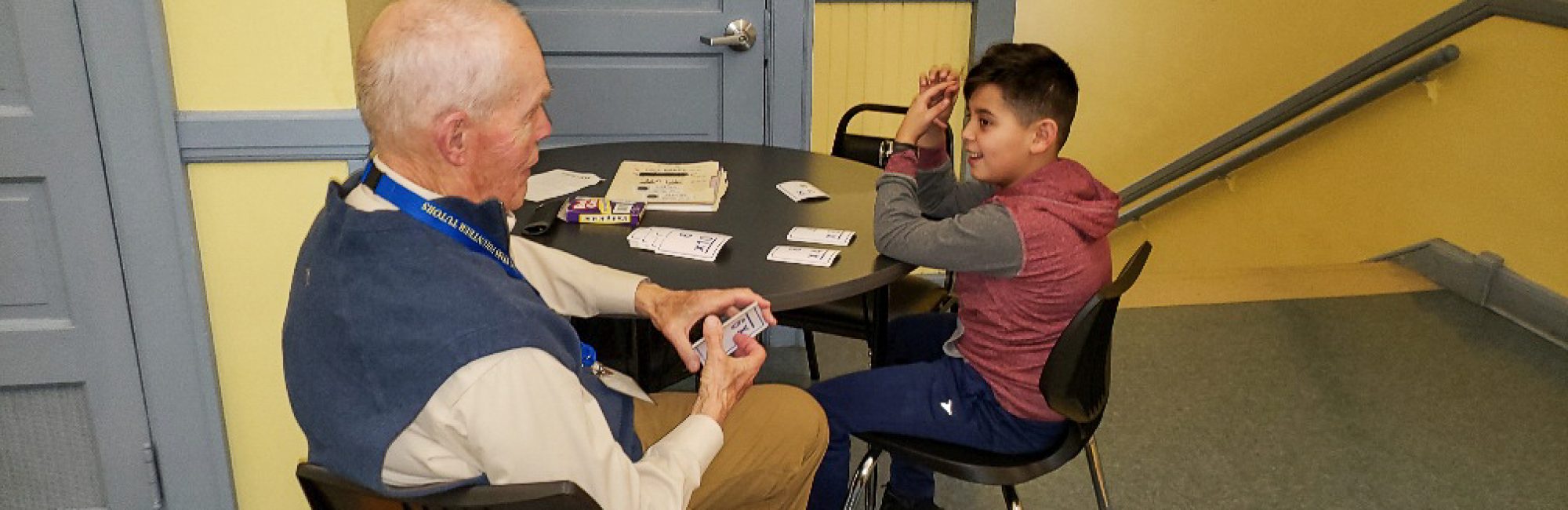 Photo of Lenny Johnson tutoring a student from Notre Dame Boys Middle School in math.